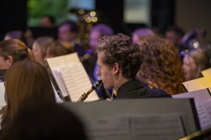 man playing clarinet at concert